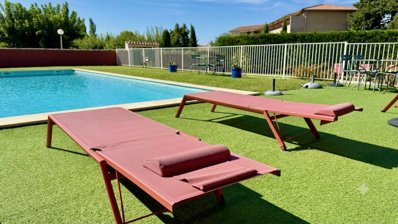 Deux transats au bord de la grande piscine de l'Hôtel La Perna